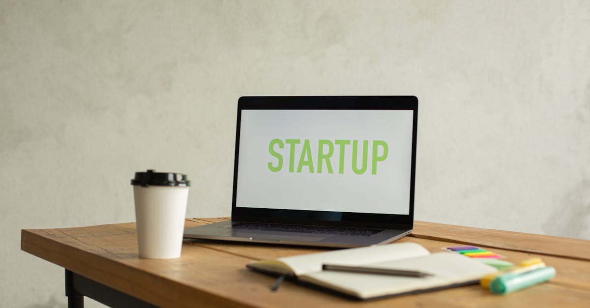 Notebook, coffee and laptop on a startup founder's desk